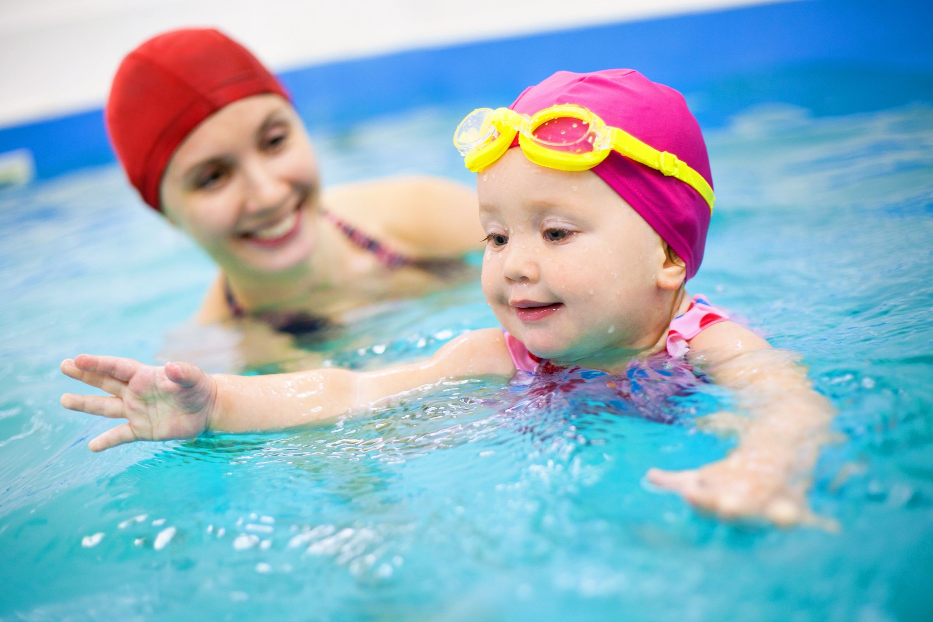 Young Child Learning How to Swim with an Adult